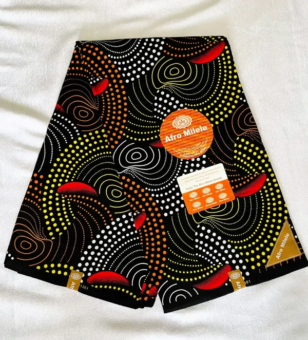 Premium Ankara/Kitenge fabric with black background, bold circular and wave-like patterns in white, yellow, orange, and red leaf-like shapes.