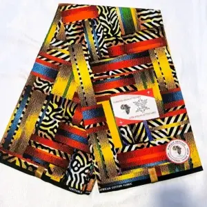 Premium Ankara/Kitenge fabric featuring bold geometric shapes and zebra-like patterns in vibrant red, yellow, blue, and black hues on a durable cotton base.