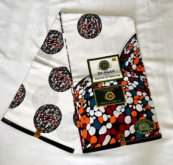 Premium Kitenge fabric featuring colorful dotted circular patterns in shades of blue, red, orange, and white on a crisp white cotton base.