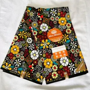 Premium Ankara/Kitenge fabric featuring vibrant multicolor floral patterns on a black cotton base, crafted from durable material.