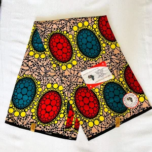 Premium Ankara/Kitenge fabric featuring bold red and teal ovals encircled by yellow accents on a beige and black cotton base.