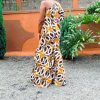 A vibrant, custom-made one-shoulder Kitenge maxi dress with intricate patterns, crafted with high-quality and durable fabric.