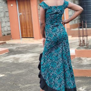 Long dress with a blue and black geometric Kitenge design, featuring a ruffled side slit. Made with authentic, high-quality fabric.