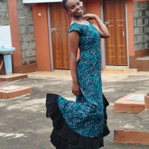 Long dress with a blue and black geometric Kitenge design, featuring a ruffled side slit. Made with authentic, high-quality fabric.