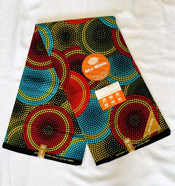 Premium Cotton Kitenge fabric with bold concentric circular patterns in red, yellow, blue, and black on durable African cotton, featuring authentic branding labels.