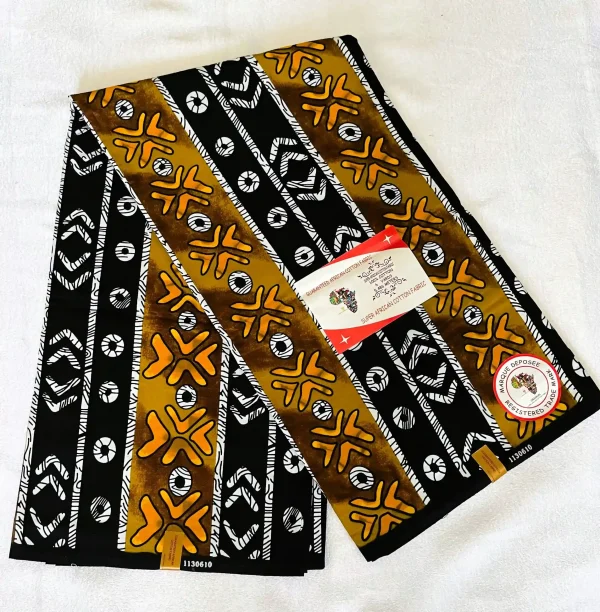 Premium Kitenge fabric featuring bold black and brownish-yellow stripes with geometric and floral designs on durable cotton