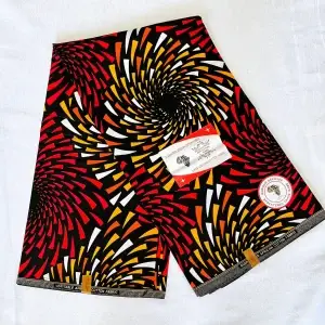 Premium Cotton Kitenge fabric featuring spiral patterns in red, yellow, orange, and white on a sleek black backdrop, crafted from durable African cotton.