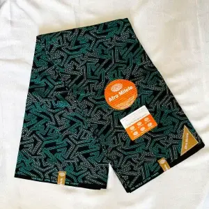 Premium Cotton Kitenge fabric featuring teal and white geometric patterns on a black background, crafted from durable African cotton.