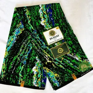 Premium Cotton Kitenge fabric featuring vibrant abstract patterns in green, blue, yellow, and white on a striking black backdrop, crafted from durable African cotton.
