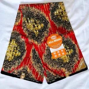 Premium Cotton Kitenge fabric featuring intricate abstract designs in bold red, black, gold, and beige on a sleek dark backdrop, crafted from durable African cotton.