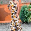 A vibrant, custom-made one-shoulder Kitenge maxi dress with intricate patterns, crafted with high-quality and durable fabric.