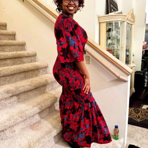A red and blue patterned off-shoulder Kitenge dress with flared sleeves and an elastic, form-fitting design suitable for all sizes.